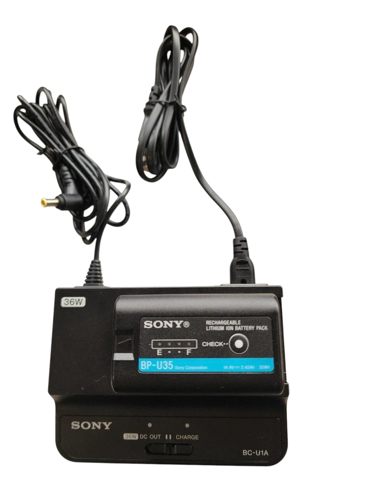 Cymer Sony BP-U35 battery pack charging on a BC-U1A charger with power cables on a marble surface.