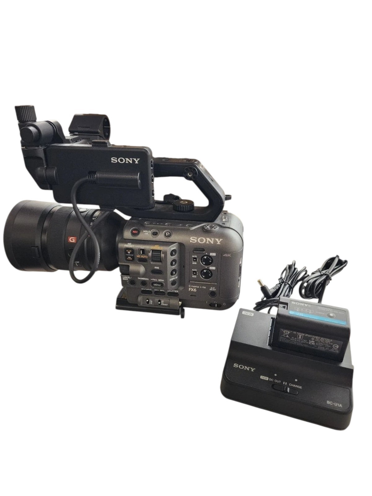 Cymer Sony FX6 full-frame cinema camera with lens, battery charger, and original box on a marble surface.